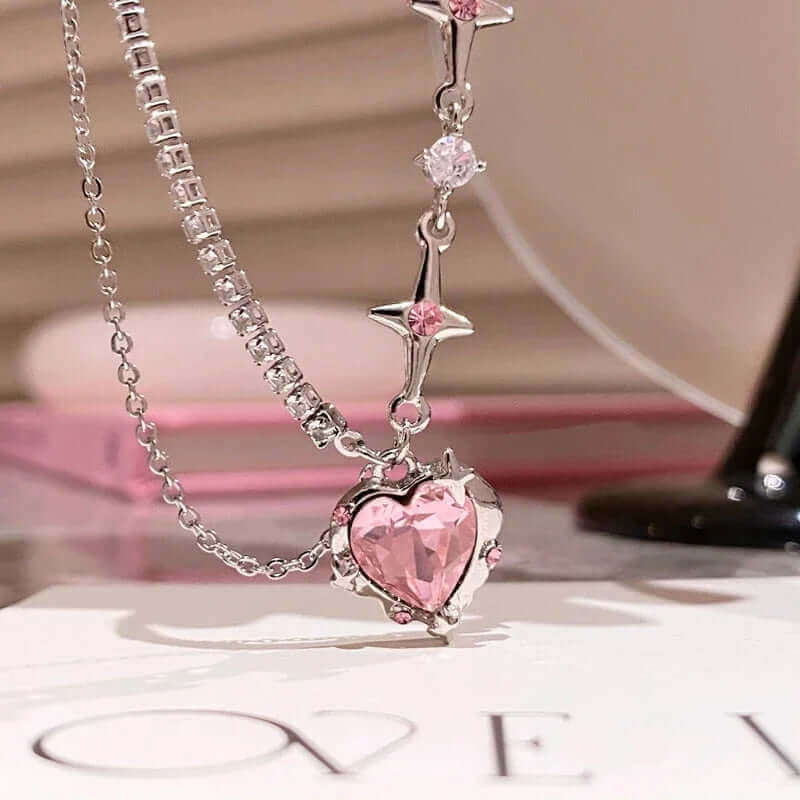 Pink heart pendant necklace with sparkling crystals and star accents, perfect for romantic gifts.