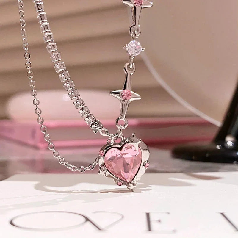 Pink heart pendant necklace with sparkling crystals and star accents, perfect for romantic gifts.