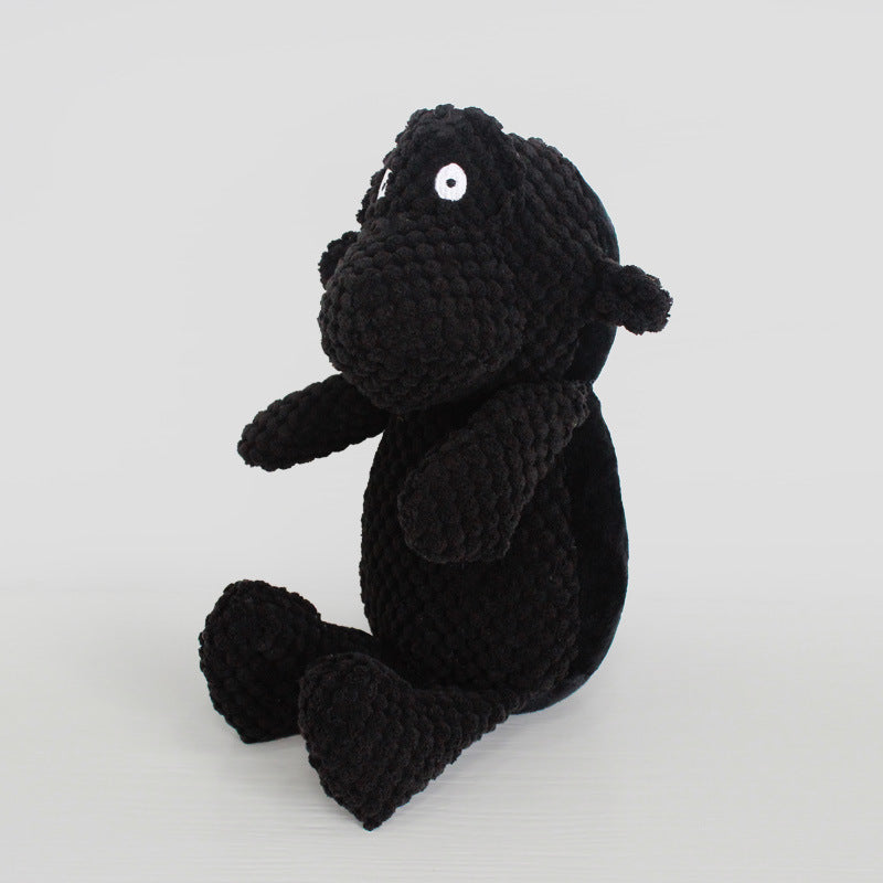 Toy Dinosaur Dog Doll Sounding Duck - plush black monkey doll in a seated position with white eyes.