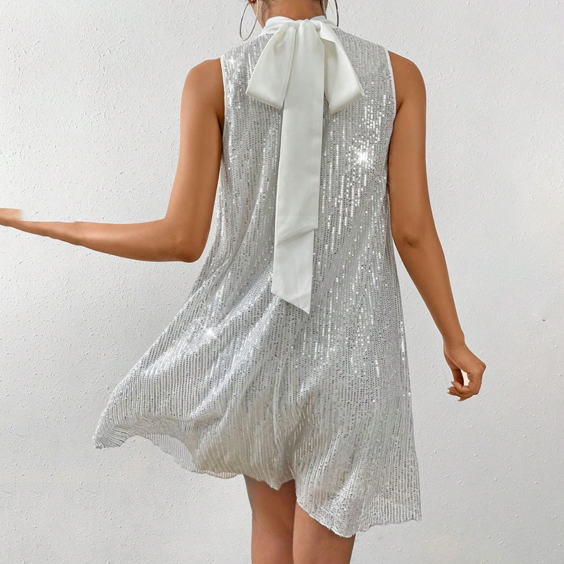 Women's sparkly sequin evening dress featuring a sleeveless design and bow detail at the back.