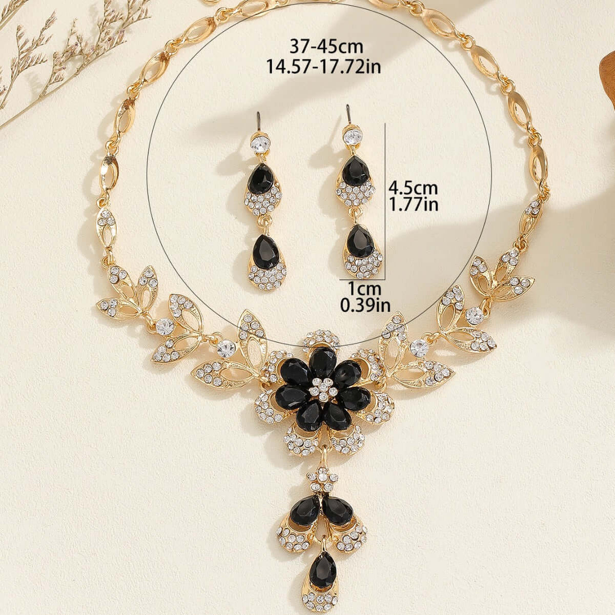 Vintage jewelry set featuring a black alloy necklace with a floral design and matching earrings.