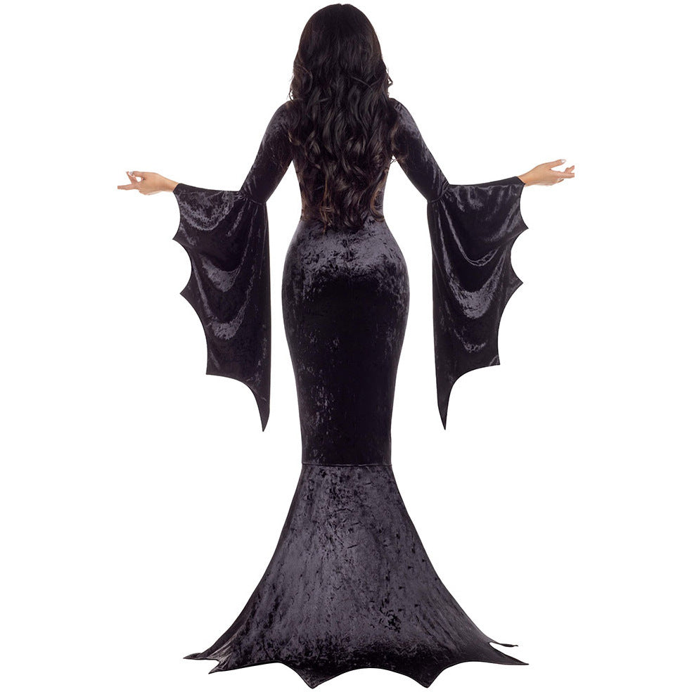 Rear view of a woman in a long black Halloween Witch Ghost Costume with bat wing sleeves made of dense velvet.
