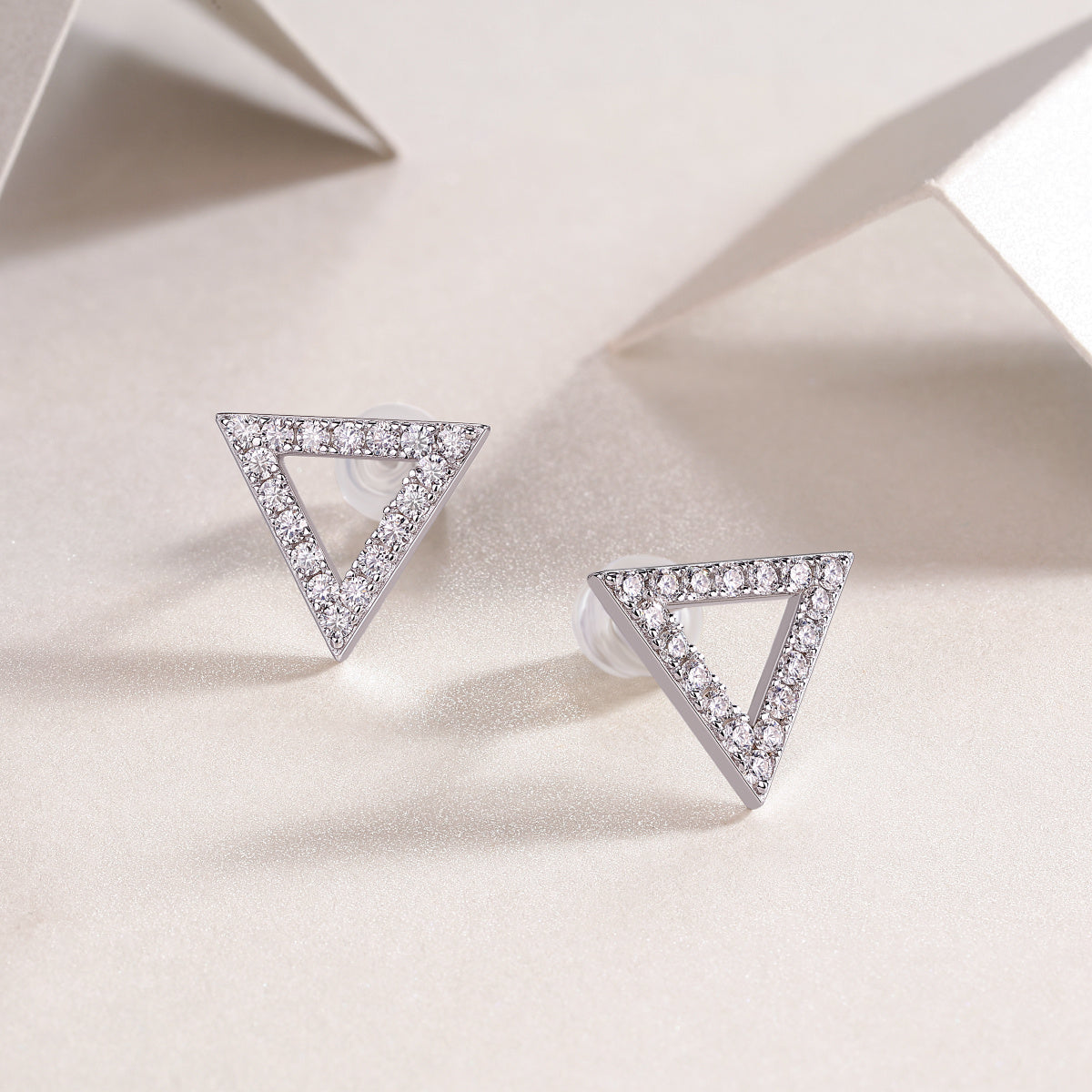 Elegant triangle moissanite stud earrings in sterling silver, perfect for trendy and affordable jewelry.