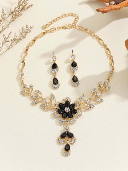 Vintage jewelry set featuring a black flower pendant necklace and matching earrings, designed with alloy and sparkling diamonds.
