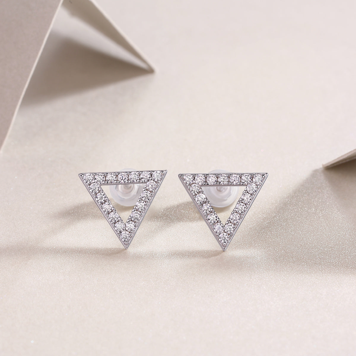 Stylish moissanite stud earrings in triangular design with sparkle, made from S925 sterling silver and platinum plating.