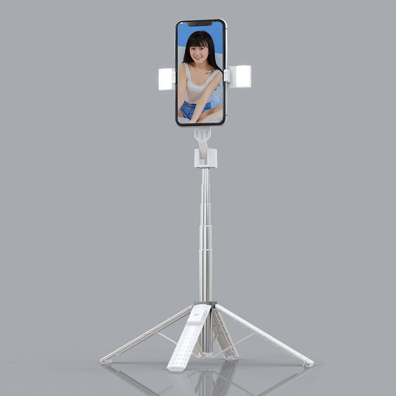 Bluetooth selfie stick with fill light attached to a smartphone on a tripod stand, showcasing adjustable features.