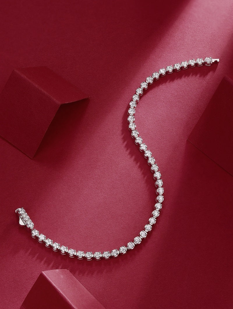 S925 Diamond Silver Bracelet stylishly displayed on a rich red background, showcasing its elegant Mosan diamonds.